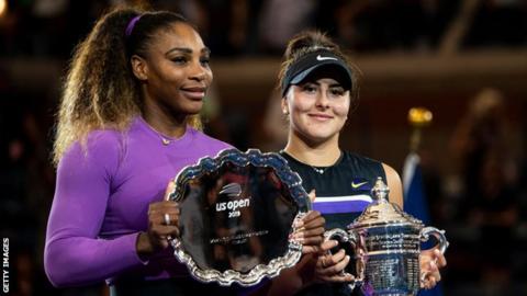 Serena Williams and Bianca Andreescu pose for photographers with their US Open trophies