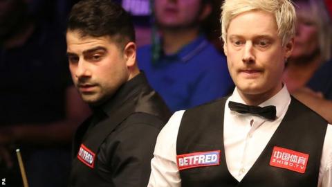 Neil Robertson (right) is watched by Michael Georgiou