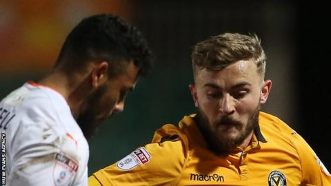 Newport's Dan Butler is tackled by Isaac Vassell of Luton Town