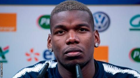 Paul Pogba told a news conference he remains happy at Manchester United