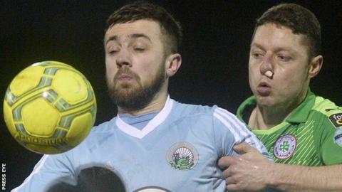 Warrenpoint's Conor McMenamin is challenged for possession by Cliftonville's Shane Grimes