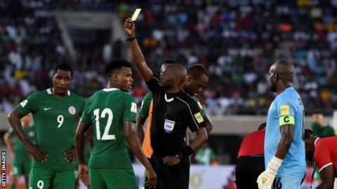 Nigeria's Abdullahi Shehu shown a yellow card against Zambia