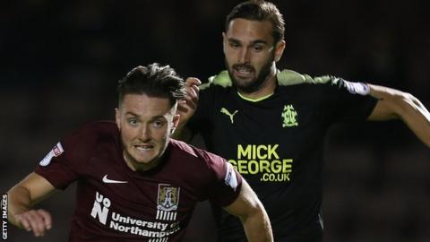 Greg Taylor (right) chases Northampton midfielder Matt Grimes