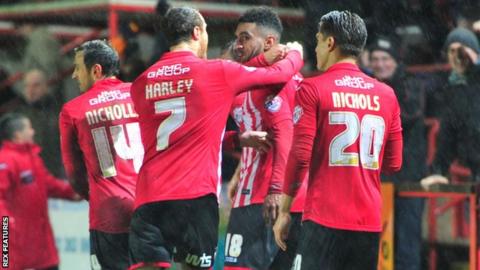 Jamie Reid celebrates Exeter's equaliser