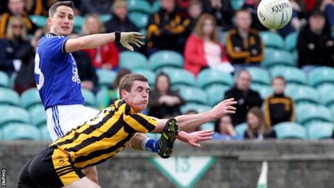Naomh Conaill's Brendan McDyer gets his shot away as Caolan Brown attempts a block in the Donegal final