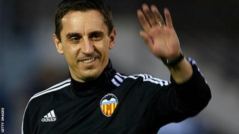 New Valencia head coach Gary Neville waves to fans at his first training session