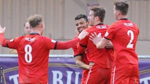 Isaac Vassell is congratulated by his teammates after his late equaliser for Truro