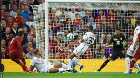 Roberto Firmino scores the opening goal at Anfield