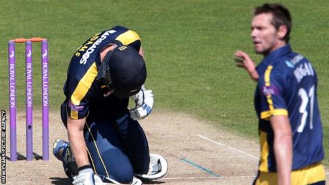 Glamorgan's Michael Hogan (right) looks on after his delivery hits Hampshire's Jimmy Adams