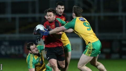 Down's Mark Poland in action against Hugh McFadden of Donegal