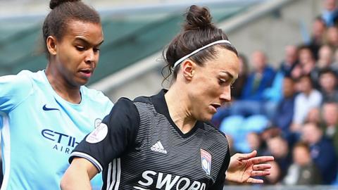 Nikita Parris of Manchester City tackles Lyon's Lucy Bronze