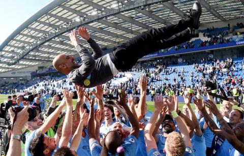 Pep Guardiola is thrown into the air by his Manchester City players as they celebrate their 2019 Premier League title