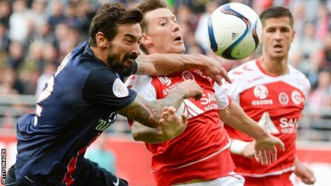 Franck Signorino of Reims challenges Paris Saint-Germain's Argentinian forward Ezequiel Lavezzi