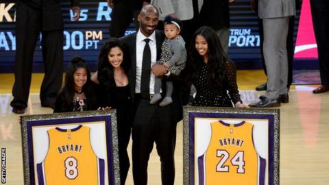 The Bryants during the game at which Kobe Bryant's number eight and 24 jerseys were retired