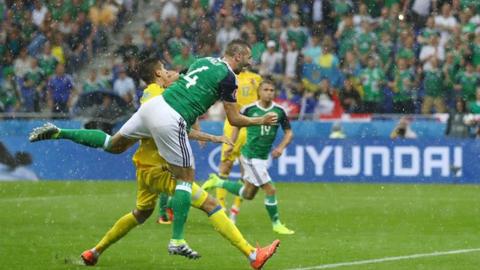 Gareth McAuley heads Northern Ireland in front against Ukraine