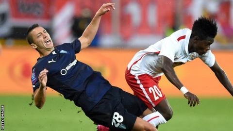 Nikola Djurdjic crashes to the turf under a challenge by Salzburg's David Atanga
