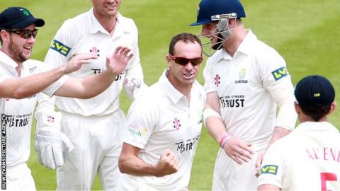 Dean Cosker celebrates with his Glamorgan team-mates