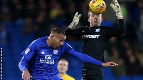 Kenneth Zohore and Chris Maxwell challenge for the ball