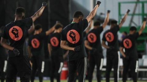 Players raised a fist to the sky as part of their protest