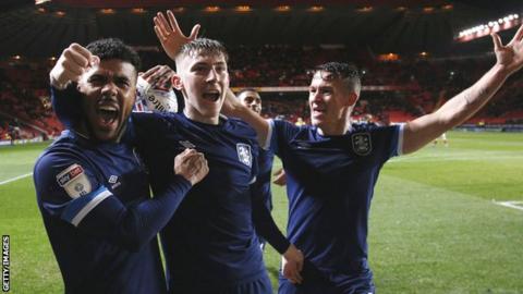 Huddersfield players celebrate Matty Daly's late goal against Charlton