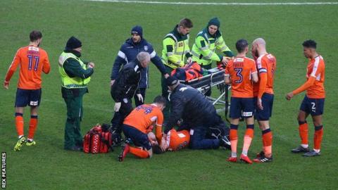 Luke Berry surrounded by paramedics