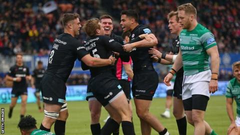 Newcastle Falcons watch as Max Malins celebrates his Saracens try
