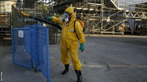 A Rio municipal worker sprays insecticide