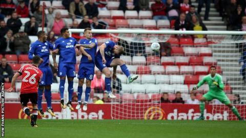The Cardiff City wall holds firm against a free kick from George Honeyman of Sunderland