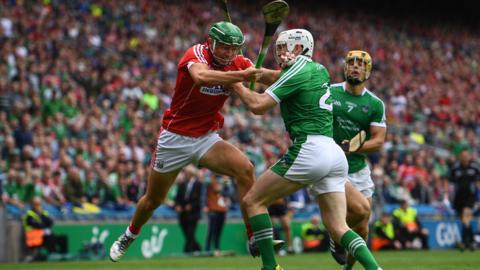Dublin, Ireland, 29 July: Robbie O'Flynn of Cork is tackled by Sean Finn of Limerick during the GAA Hurling All-Ireland Senior Championship semi-final match at Croke Park. (Photo By Ramsey Cardy/Sportsfile via Getty Images)