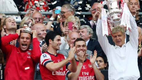 Mikel Arteta watches then Arsenal manager Arsene Wenger lift the FA Cup in 2014