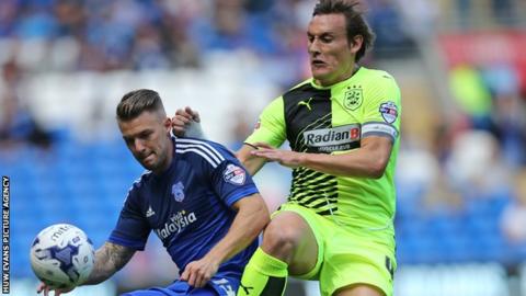 Cardiff's Anthony Pilkington shields the ball from Huddersfield's Dean Whitehead