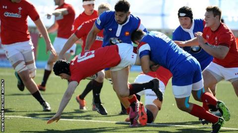 Ioan Davies of Wales drives through the tackle of Arthur Vincent