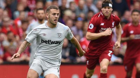 Jack Wilshire challenges James Milner