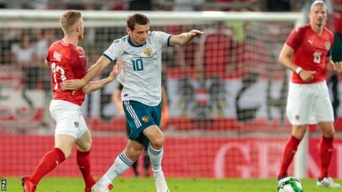 Austria's Florian Kainz and Russia's Alan Dzagoev in action during the international friendly