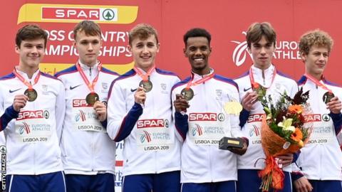 Great Britain's under-20 men's squad smile on the podium after winning team gold at the European Cross Country Championships in Lisbon