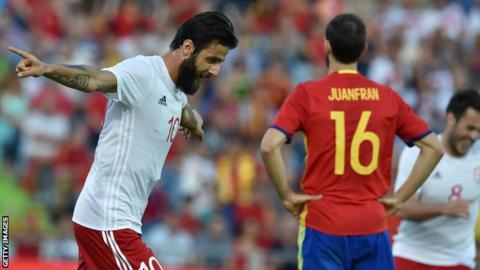 Tornike Okriashvili (left) celebrates his winner for Georgia