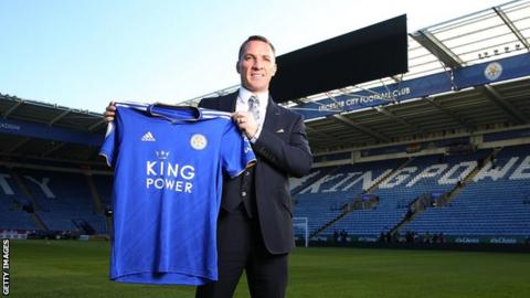 Brendan Rodgers holds up a Leicester shirt