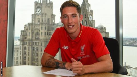 Harry Wilson poses for a photo as he signs his Liverpool contract
