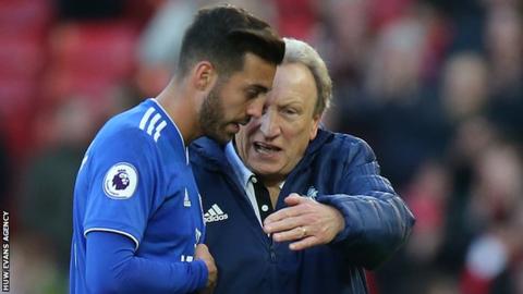 Midfielder Victor Camarasa talks tactics with Cardiff manager Neil Warnock