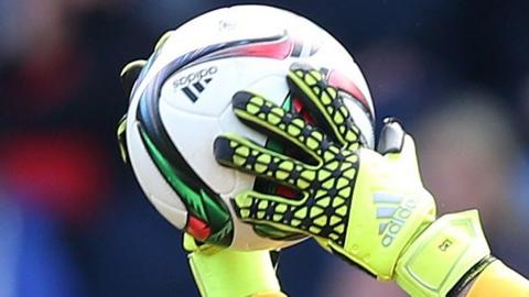 Goalkeeper catches ball