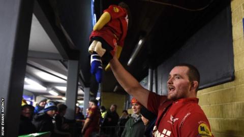 Scarlets captain Ken Owens holds aloft the Rag Doll Scarlets and Bath have competed for since 1921