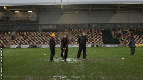 Ground staff work on the Rodney Parade pitch
