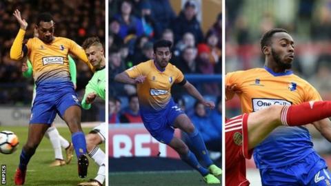 Mansfield players Krystian Pearce (left), Mal Benning (centre) and Omari Sterling-James