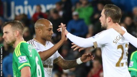 Andrew Ayew and Gylfi Sigurdsson celebrate a Swansea goal