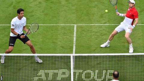 Andy Murray plays a volley in his doubles match alongside Marcelo Melo at Eastbourne