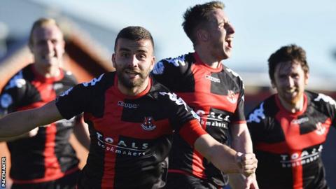 Crusaders captain Colin Coates leads the celebrations after Michael Carvill makes it 3-3 against Cliftonville