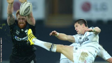 Lloyd Williams (right) has a kick charged down by Dan Baker during Cardiff Blues' defeat to Ospreys