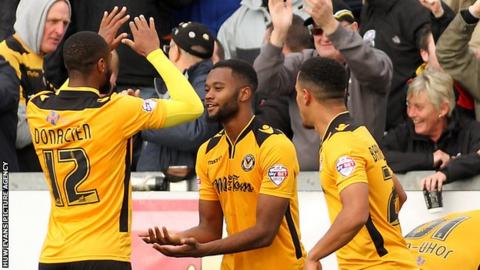 Zak Ansah (centre) celebrates his goal fro Newport