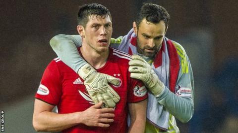 Aberdeen captain Joe Lewis with Scott McKenna