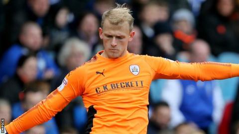 Barnsley keeper Adam Davies clears the ball